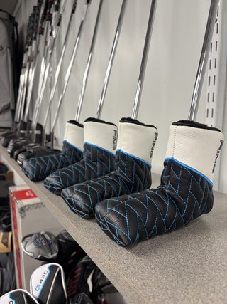 Driver headcovers lined up on the shelf