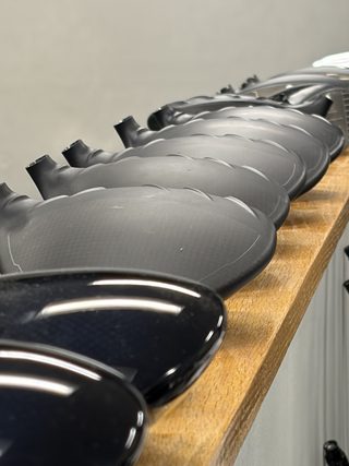 Driver heads lined up on the bench
